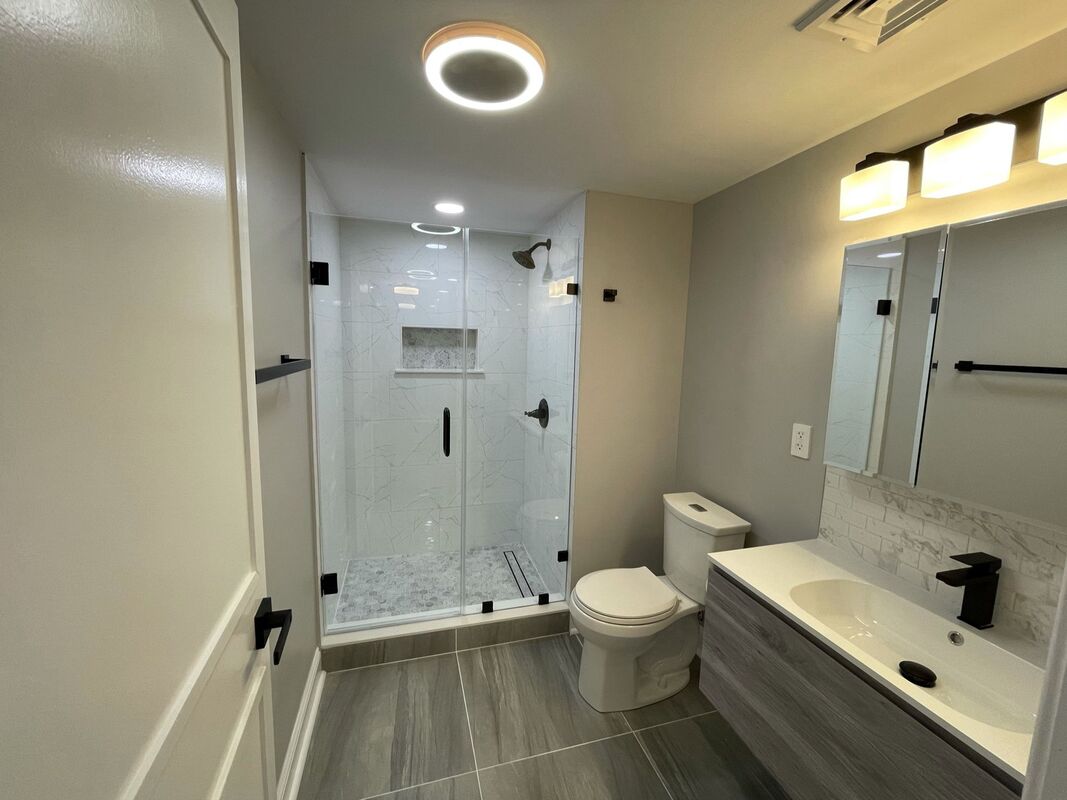 Bathroom remodel with glass shower and floating vanity