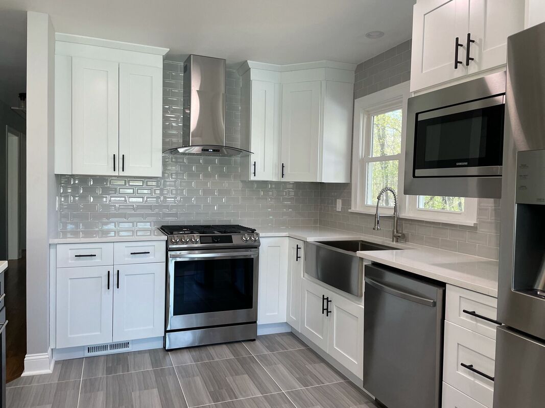 White shaker kitchen with subway tile and farmhouse sink